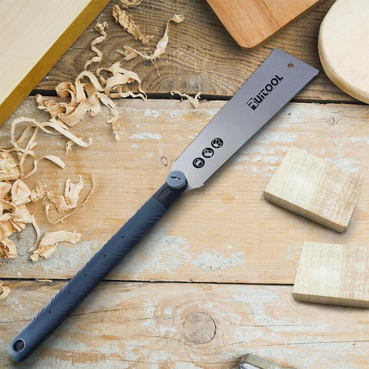 The RUITOOL 10 inch ryoba pull saw lying on a workbench among shavings